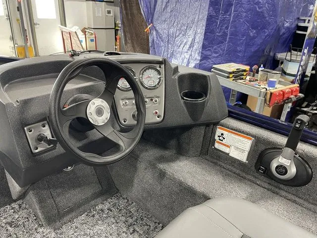 Slide: The Image of Interior of 2026 Tracker Pro Guide V-16 SC with steering console. - 25