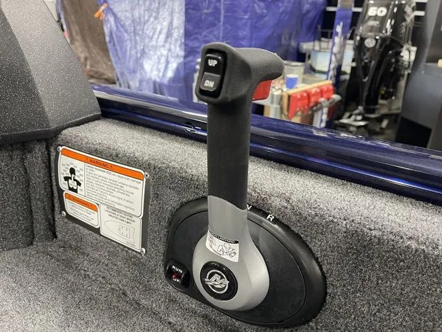 Slide: The Image of Close-up of control lever on a 2026 Tracker Pro Guide V-16 SC boat. - 28