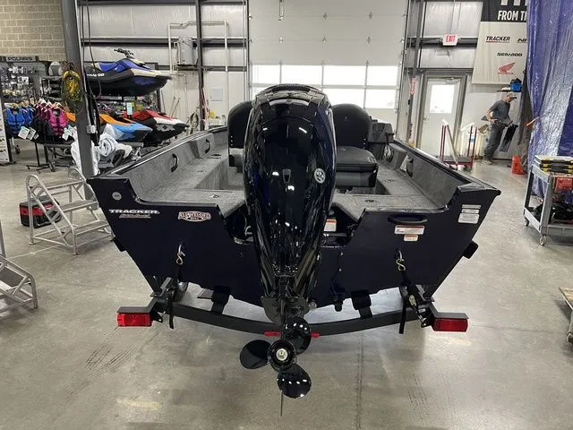 Slide: The Image of 2026 Tracker Pro Guide V-16 SC boat in showroom. - 7