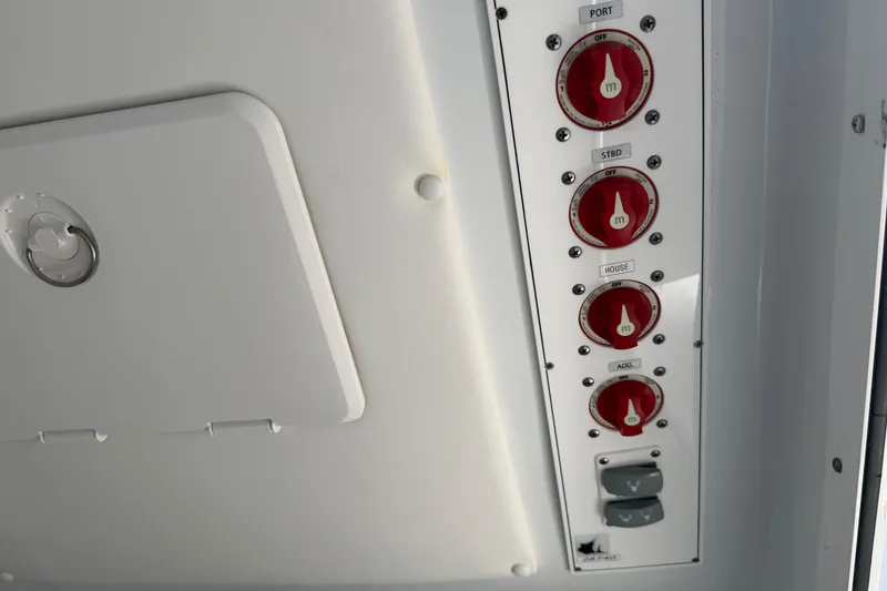 Slide: The Image of Control panel of a 2023 Contender 28 Tournament boat with red switches and labels. - 10