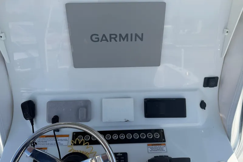 Slide: The Image of Helm of 2023 Contender 28 Tournament boat featuring Garmin navigation system. - 11