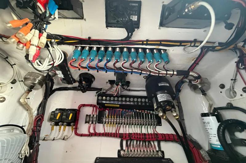 Slide: The Image of Electrical wiring and components inside a 2023 Contender 28 Tournament boat. - 14