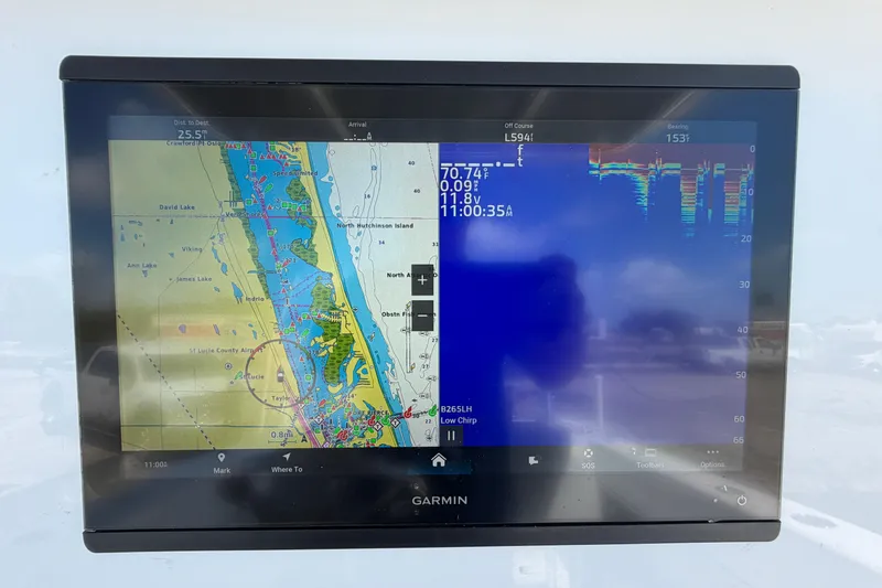 Slide: The Image of Garmin marine display showing navigation and sonar data on a 2023 Contender 28 Tournament boat. - 15