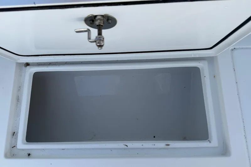 Slide: The Image of Open storage compartment on 2023 Contender 28 Tournament boat. - 19