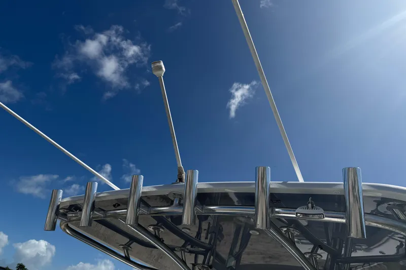 Slide: The Image of 2023 Contender 28 Tournament boat with rod holders against a clear blue sky. - 20