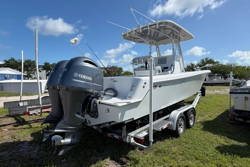 Slide: The Image of 2023 Contender 28 Tournament boat with Yamaha engines on a trailer, outdoors. - 24