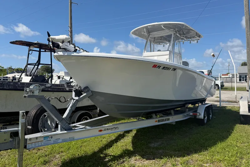 Slide: The Image of 2023 Contender 28 Tournament boat on trailer, parked outdoors under blue sky. - 26
