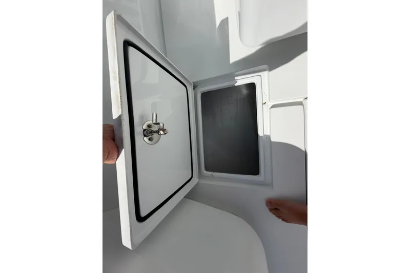 Slide: The Image of Open hatch on 2023 Contender 28 Tournament boat, showcasing storage compartment. - 30