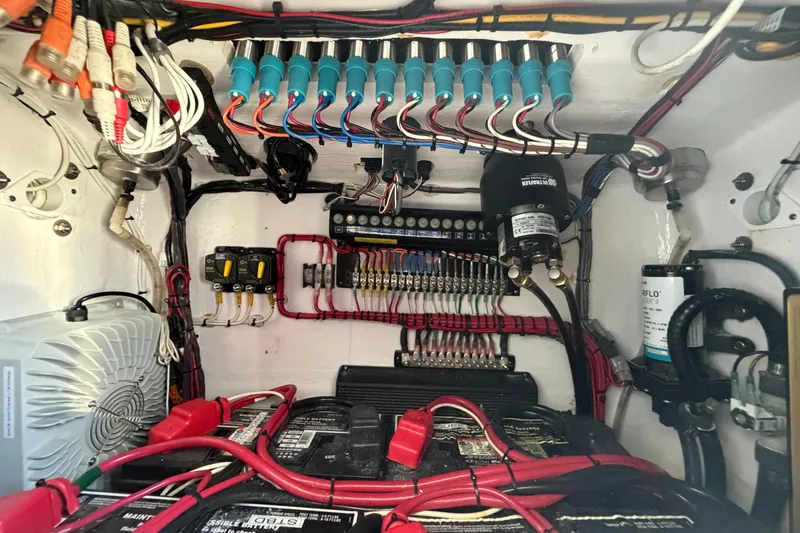 Slide: The Image of Electrical wiring and components inside a 2023 Contender 28 Tournament boat. - 32