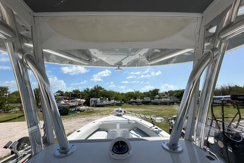 Slide: The Image of 2023 Contender 28 Tournament boat interior view with clear sky and parked boats in background. - 34