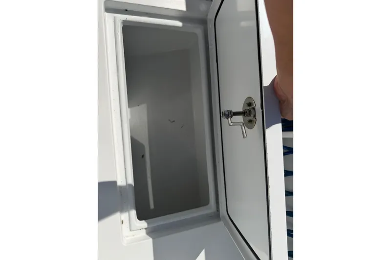 Slide: The Image of Open storage compartment on 2023 Contender 28 Tournament boat. - 38