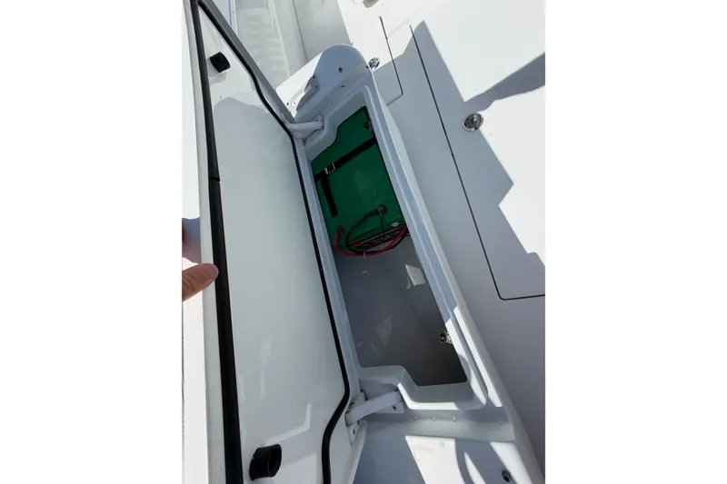 Slide: The Image of Open storage compartment on 2023 Contender 28 Tournament boat, showing interior details. - 5