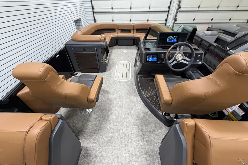 Slide: The Image of Luxurious interior of 2025 Bennington M Quad Bench 24 MFB pontoon boat with tan seating. - 12