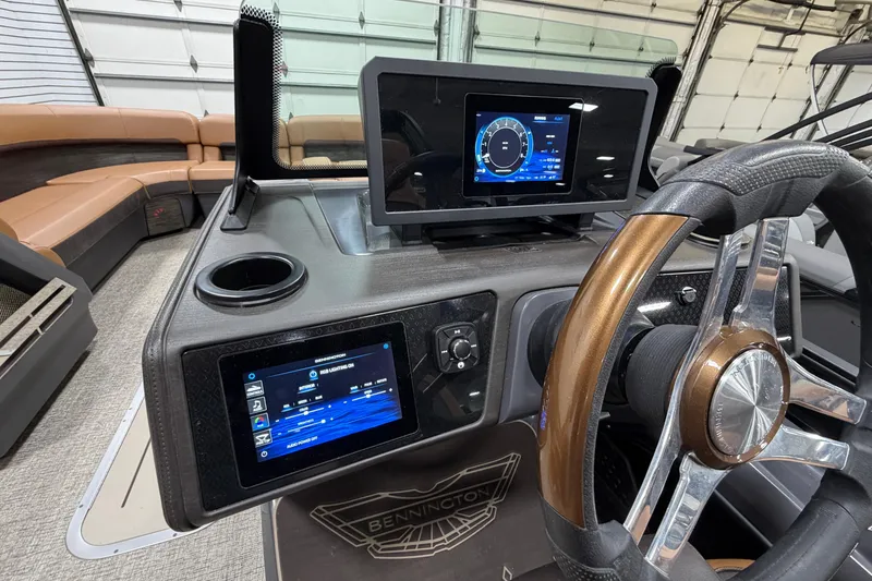 Slide: The Image of 2025 Bennington M Quad Bench 24 MFB boat dashboard with modern controls and steering wheel. - 13