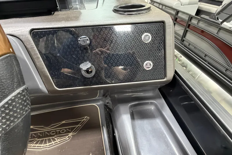 Slide: The Image of Control panel of 2025 Bennington M Quad Bench 24 MFB boat with horn and power buttons. - 15