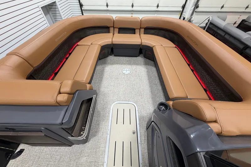 Slide: The Image of Luxurious interior of 2025 Bennington M Quad Bench 24 MFB with tan seating and ambient lighting. - 21