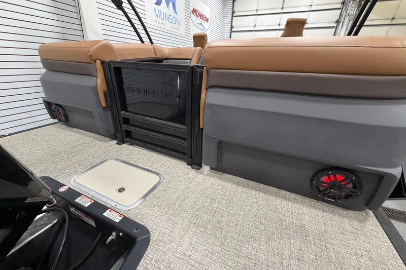 Slide: The Image of 2025 Bennington M Quad Bench 24 MFB interior with tan seating and speakers. - 7