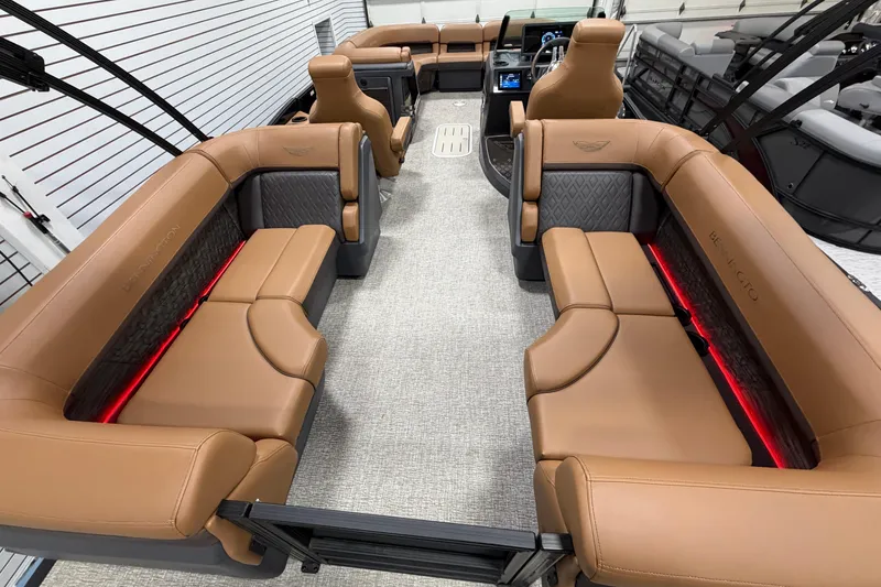 Slide: The Image of Luxurious interior of 2025 Bennington M Quad Bench 24 MFB pontoon boat with tan seating. - 8