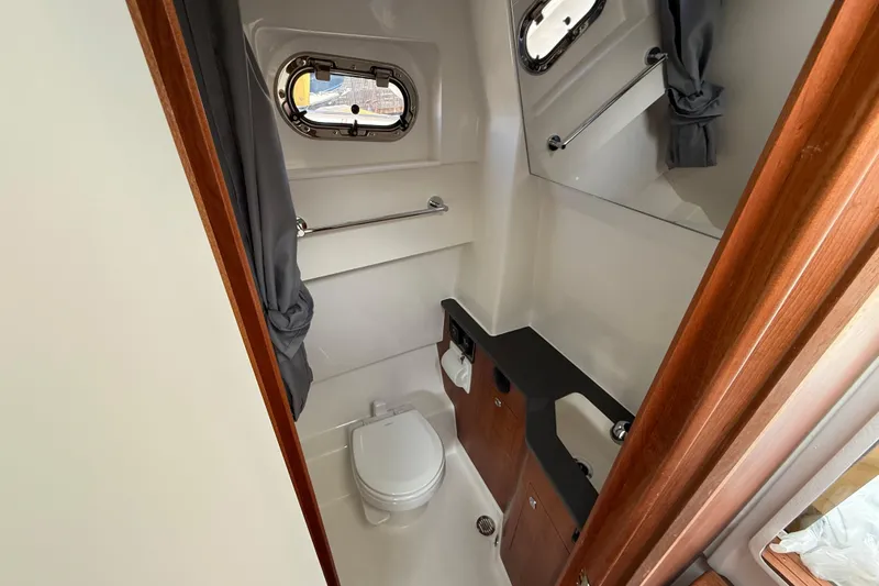 Slide: The Image of Compact bathroom in 2026 Pursuit S 358 Sport boat with toilet and sink. - 16