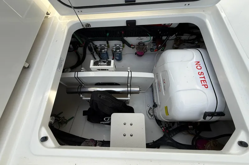 Slide: The Image of Engine compartment of 2026 Pursuit S 358 Sport boat, featuring mechanical components and "No Step" warning. - 17
