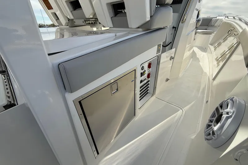 Slide: The Image of 2026 Pursuit S 358 Sport boat interior with control panel and seating area. - 7
