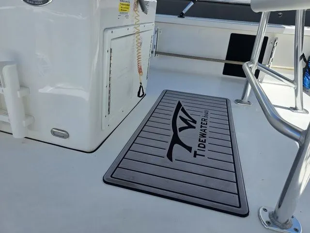 Slide: The Image of Tidewater 1910 Bay Max 2024 boat deck with logo and seating area. - 16