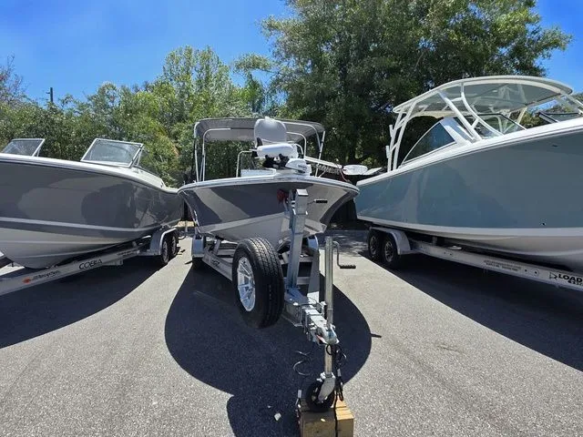Slide: The Image of 2024 Tidewater 1910 Bay Max boat on trailer between two other boats. - 6