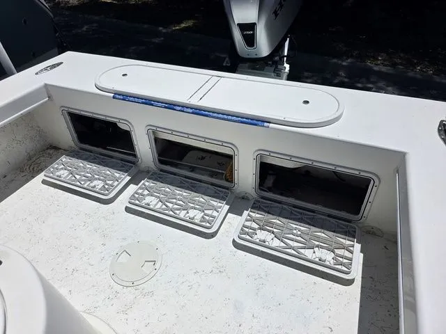 Slide: The Image of 2023 C-Hawk 25 Center Console with storage compartments and motor. - 13