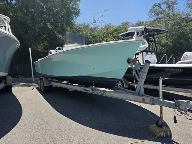 Slide: The Image of 2023 C-Hawk 25 Center Console on trailer outdoors. - 28