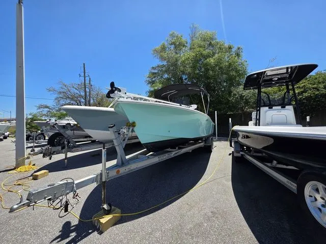 Slide: The Image of 2023 C-Hawk 25 Center Console on trailer outdoors. - 8