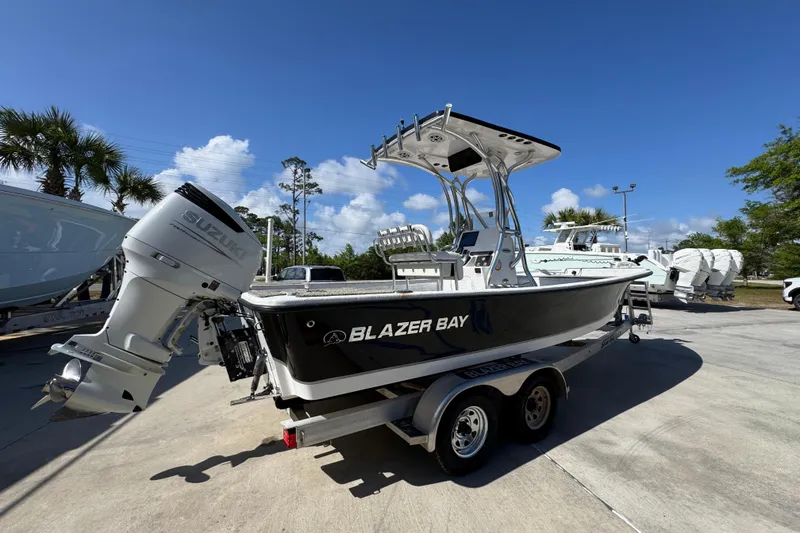 Slide: The Image of 2021 Blazer Bay 2400 boat with Suzuki engine on trailer under clear blue sky. - 12