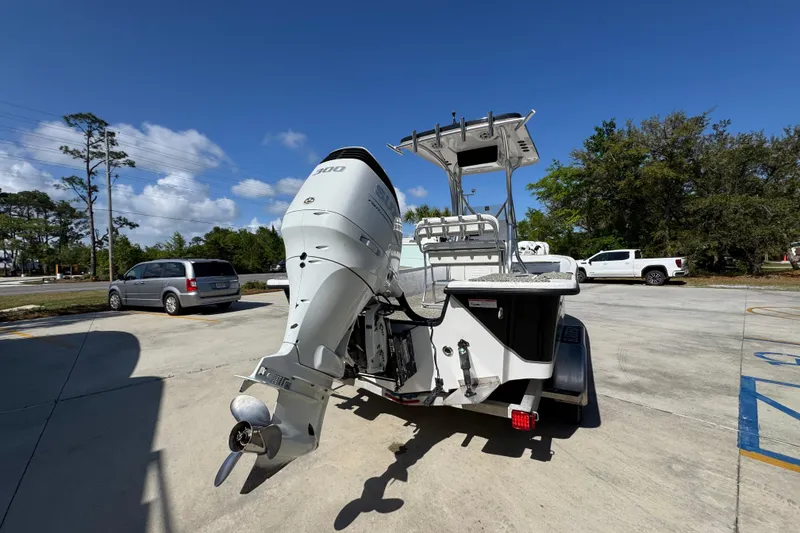 Slide: The Image of 2021 Blazer Bay 2400 boat with powerful outboard motor in a sunny parking lot. - 14