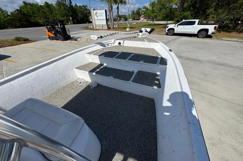 Slide: The Image of 2021 Blazer Bay 2400 boat interior with seating and storage compartments in a parking lot. - 18