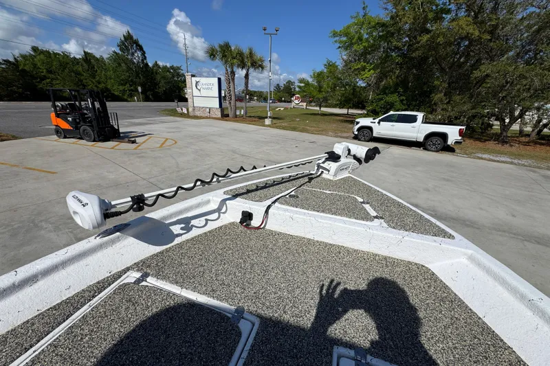 Slide: The Image of Bow of 2021 Blazer Bay 2400 boat with trolling motor in parking lot. - 21