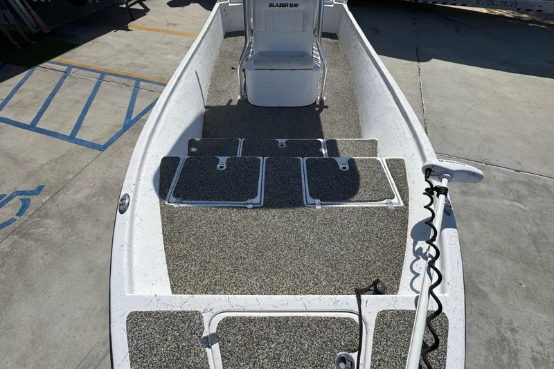 Slide: The Image of 2021 Blazer Bay 2400 boat interior with textured flooring and seating. - 23