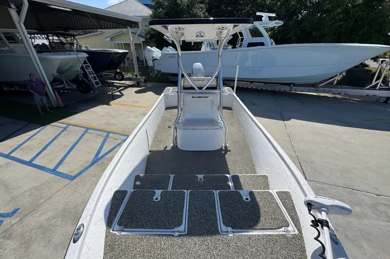 Slide: The Image of 2021 Blazer Bay 2400 boat with center console, parked in a marina. - 24