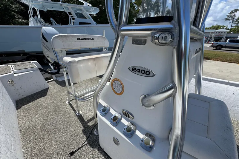 Slide: The Image of 2021 Blazer Bay 2400 boat interior with seating and control panel. - 27