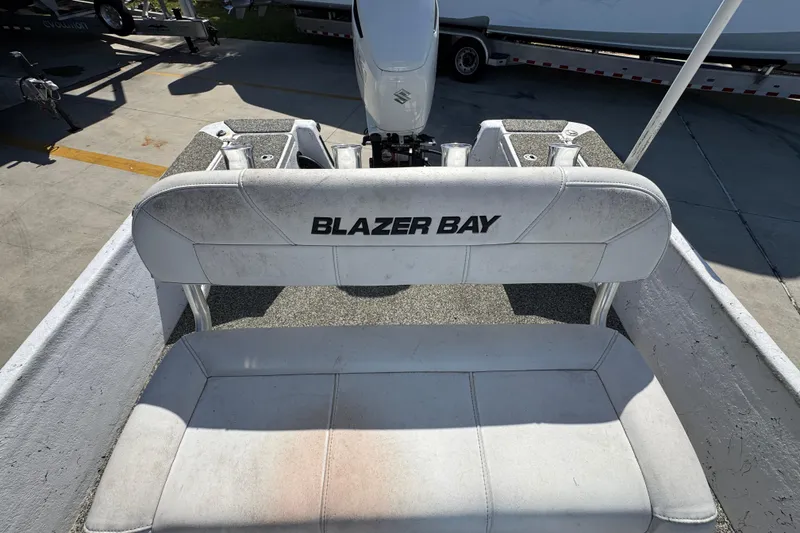Slide: The Image of 2021 Blazer Bay 2400 boat seat with logo, outdoor setting. - 29