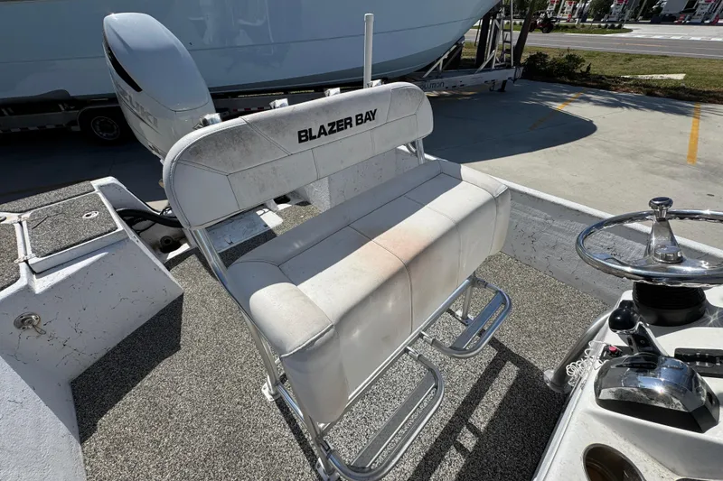Slide: The Image of Blazer Bay 2400 boat seat and controls, 2021 model, in outdoor setting. - 30