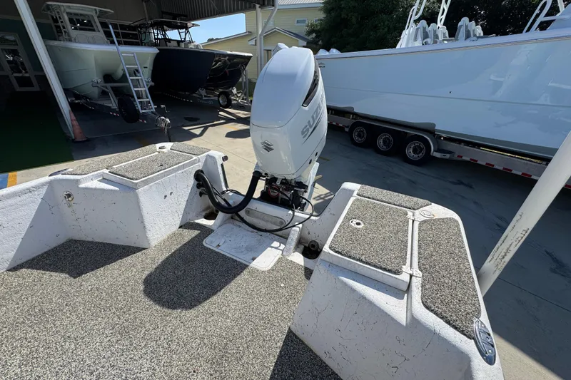 Slide: The Image of 2021 Blazer Bay 2400 boat with Suzuki outboard motor in a marina setting. - 34