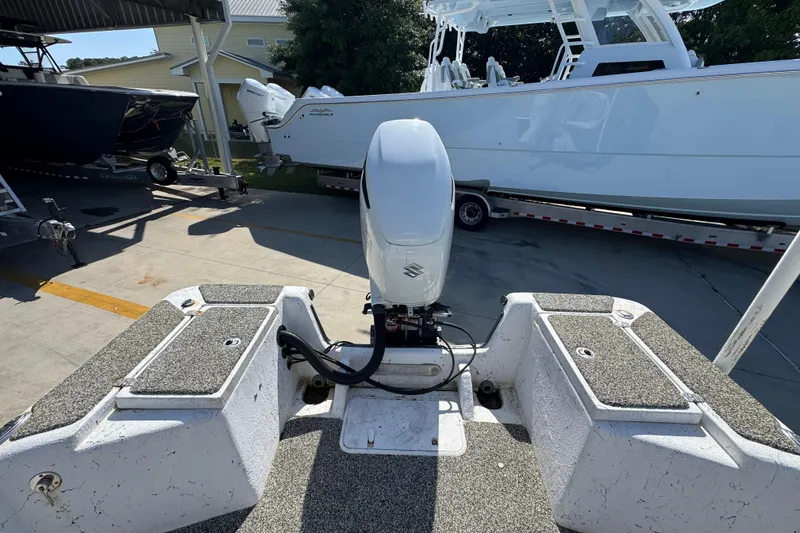 Slide: The Image of 2021 Blazer Bay 2400 boat with Suzuki outboard motor in a marina setting. - 35