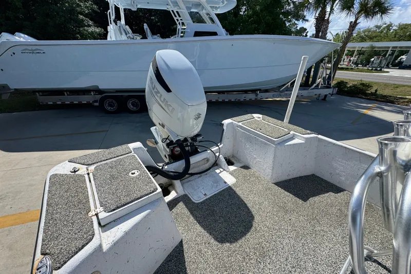 Slide: The Image of 2021 Blazer Bay 2400 boat with Suzuki outboard motor, parked on a trailer. - 36