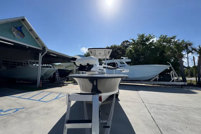 Slide: The Image of 2021 Blazer Bay 2400 boat displayed outdoors under clear blue sky. - 6