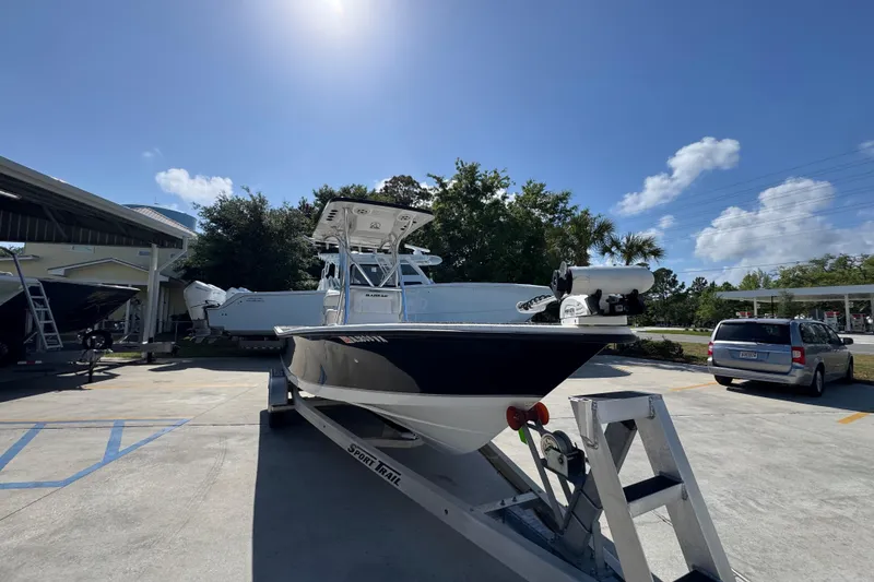 Slide: The Image of 2021 Blazer Bay 2400 boat on trailer under clear blue sky. - 7