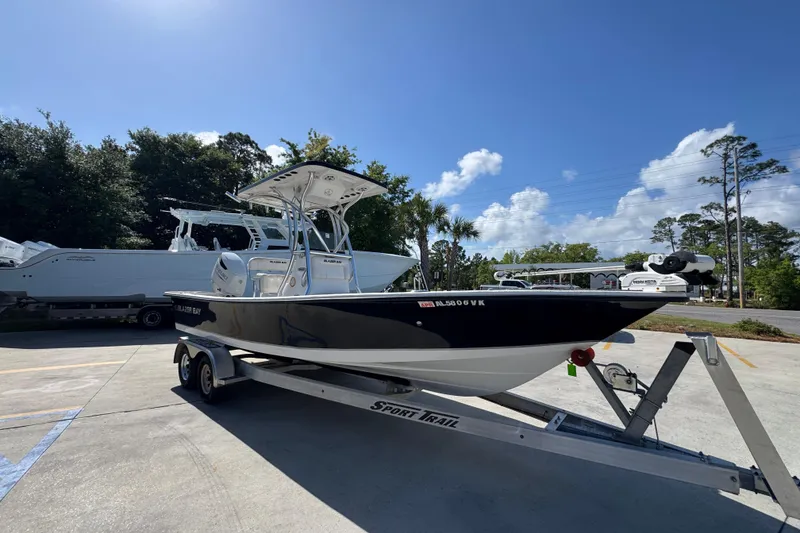 Slide: The Image of 2021 Blazer Bay 2400 boat on trailer under clear blue sky. - 8