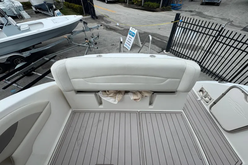 Slide: The Image of 2009 Chaparral Signature 250 boat interior with cushioned seating and storage compartment. - 10