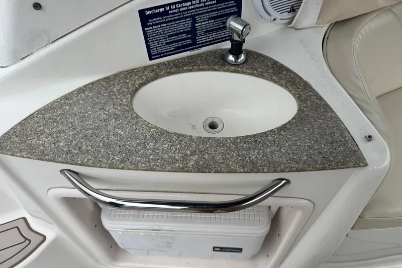 Slide: The Image of 2009 Chaparral Signature 250 boat sink with granite countertop and storage compartment. - 13