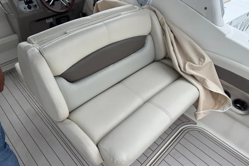 Slide: The Image of 2009 Chaparral Signature 250 boat interior with beige leather seating and steering wheel. - 14