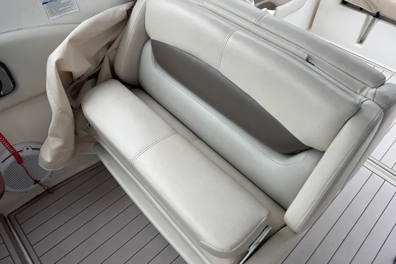 Slide: The Image of 2009 Chaparral Signature 250 boat interior with beige leather seating and speaker. - 15