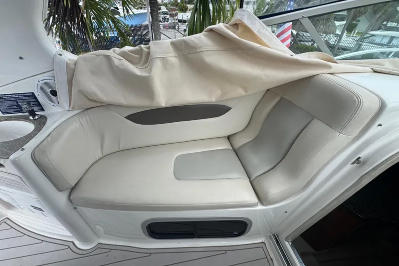 Slide: The Image of 2009 Chaparral Signature 250 boat interior with beige seating and covered area. - 17
